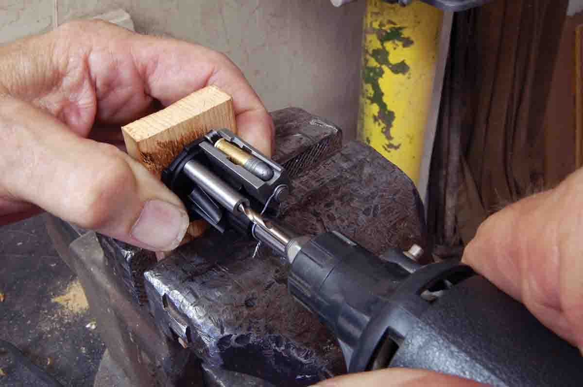 The drill guide is shown properly placed on the rotor. It is touching the cartridge groove only at the rear and is perpendicular to the magazine back plate.